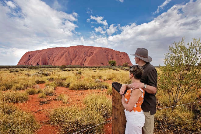 couple looking at red rocks in uluru